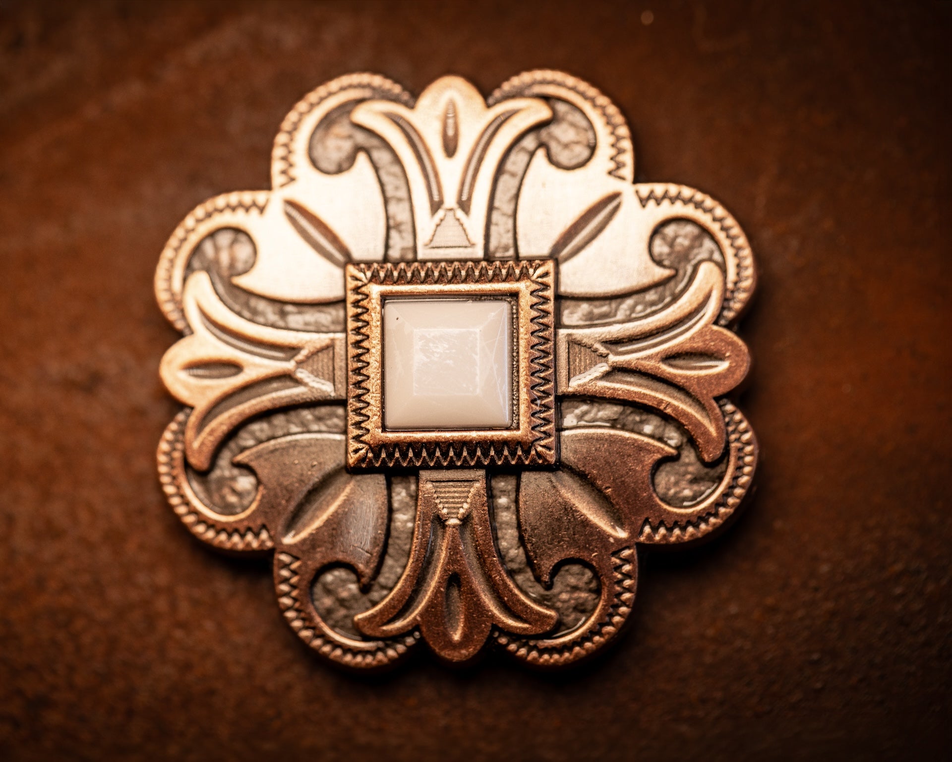 1.5” copper floral concho with white stone